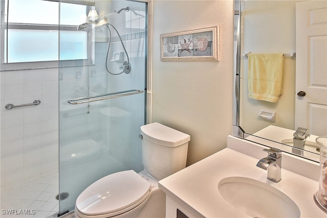 full bath with vanity, toilet, and a shower stall