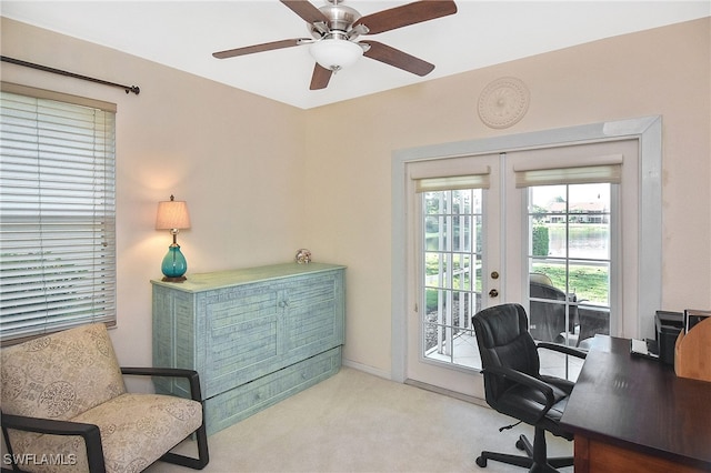 home office featuring french doors, a ceiling fan, and carpet