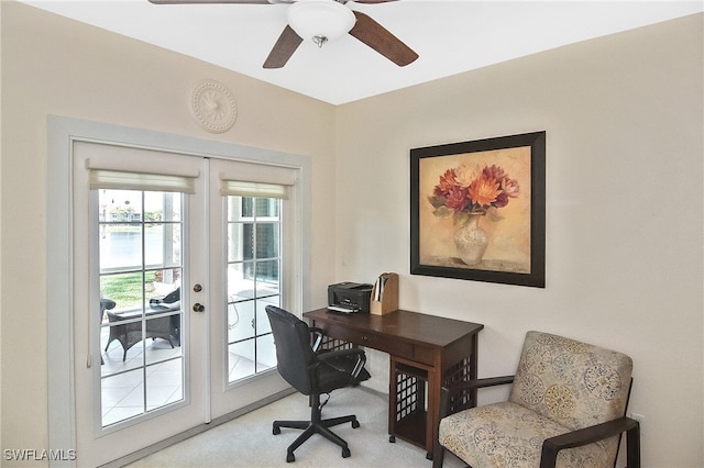 home office featuring ceiling fan, light carpet, and french doors