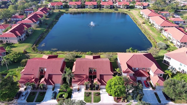 drone / aerial view with a water view and a residential view