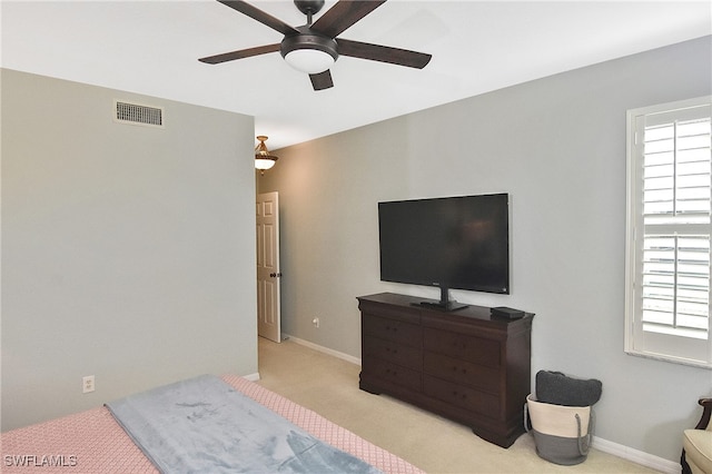 carpeted bedroom featuring visible vents, a ceiling fan, and baseboards