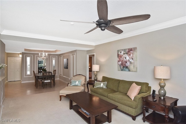 living area with light colored carpet, crown molding, baseboards, ceiling fan with notable chandelier, and light tile patterned flooring