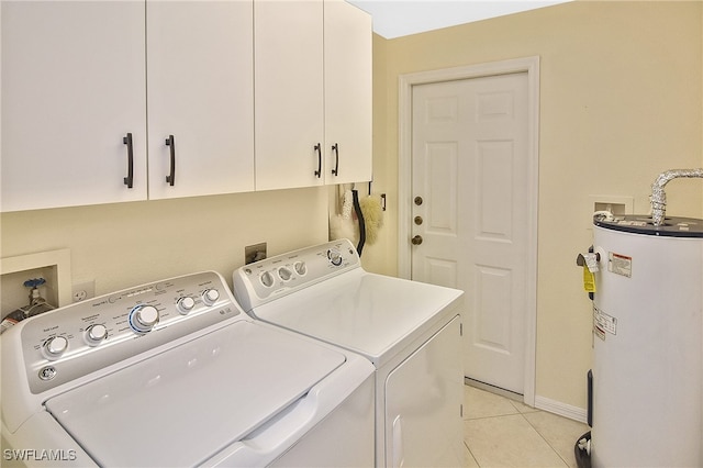 washroom with cabinet space, light tile patterned flooring, water heater, baseboards, and washer and clothes dryer