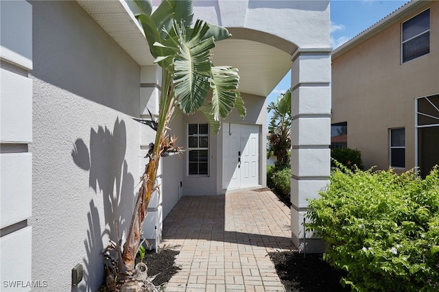 entrance to property with stucco siding