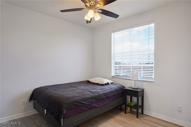 bedroom with baseboards, a ceiling fan, and wood finished floors