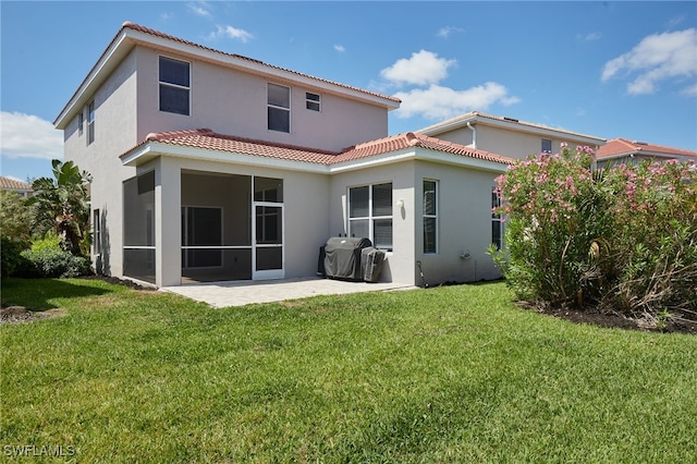 back of house featuring a patio, stucco siding, a yard, and a tile roof
