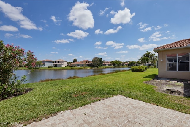 view of yard with a patio, a water view, and a residential view