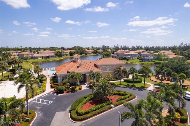 drone / aerial view featuring a water view and a residential view