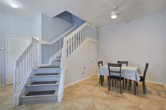 dining space featuring stairway, baseboards, and a ceiling fan