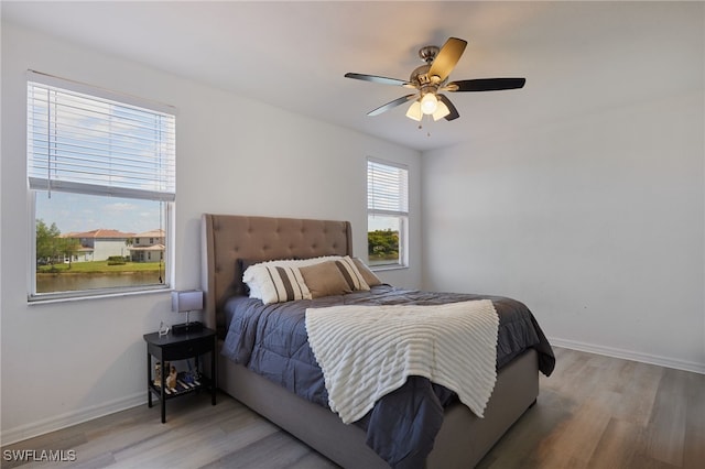 bedroom featuring baseboards, ceiling fan, and wood finished floors