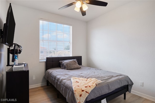 bedroom with baseboards, a ceiling fan, and wood finished floors