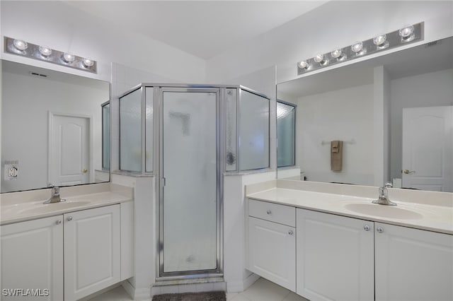 full bathroom with a sink, visible vents, a shower stall, and two vanities