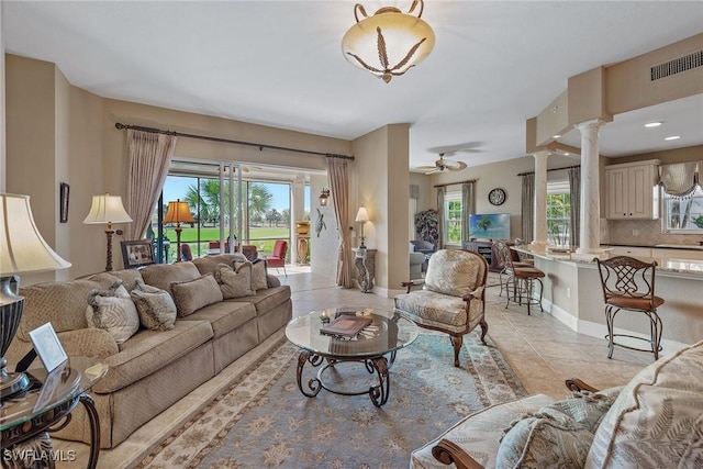 9030 Cascada Way Unit 102, Naples, FL 34114 - living room featuring ornate columns, a ceiling fan, visible vents, and light tile patterned floors
