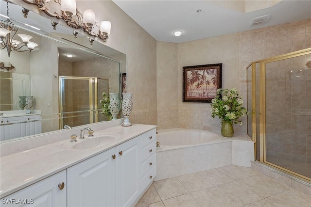 9030 Cascada Way Unit 102, Naples, FL 34114 - bathroom featuring an inviting chandelier, tile patterned flooring, vanity, a bath, and a stall shower