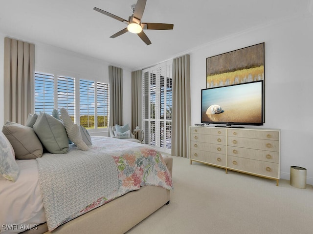 bedroom with carpet flooring, a ceiling fan, and crown molding