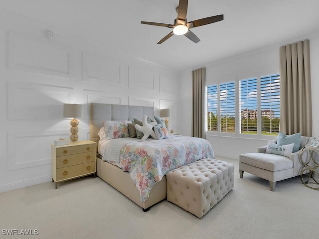 bedroom featuring light colored carpet and ceiling fan