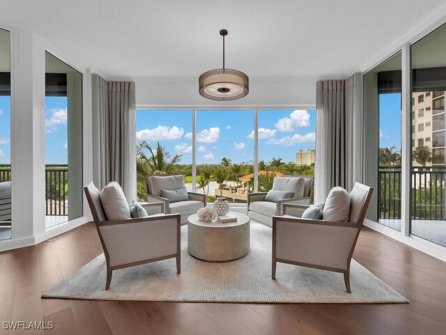 4800 Pelican Colony Blvd Unit 304, Bonita Springs, FL 34134 - living area with plenty of natural light, hardwood / wood-style floors, and crown molding