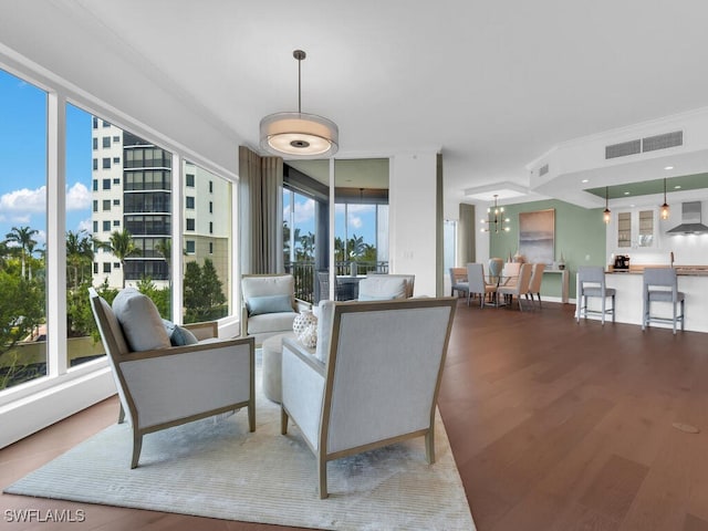 living area featuring wood finished floors and a chandelier