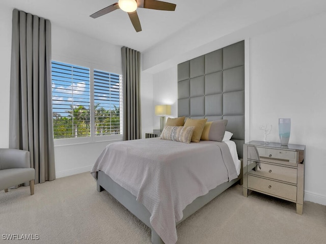 bedroom featuring carpet floors, baseboards, and a ceiling fan