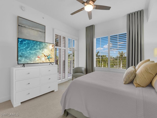 bedroom featuring light carpet, access to outside, ceiling fan, and baseboards