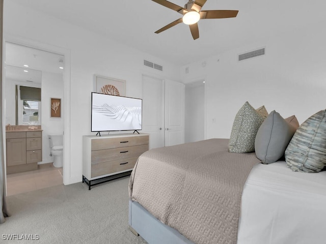 bedroom with light colored carpet, connected bathroom, recessed lighting, and ceiling fan