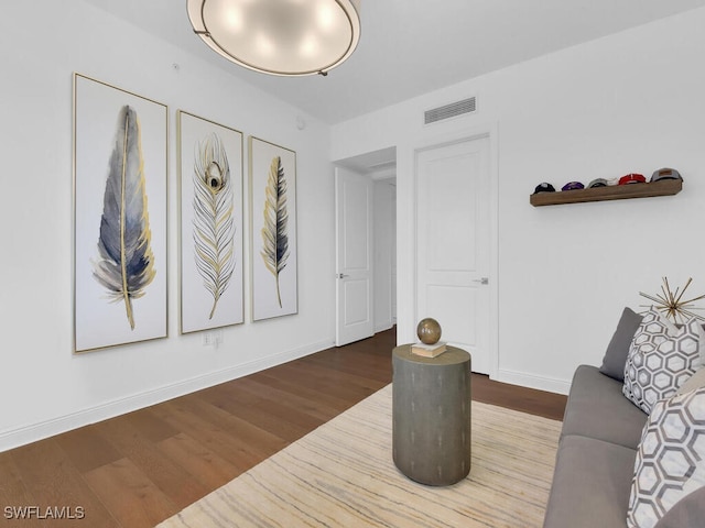 living area featuring wood finished floors and baseboards
