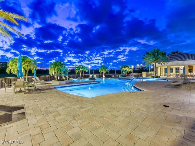 community pool featuring a patio area and fence
