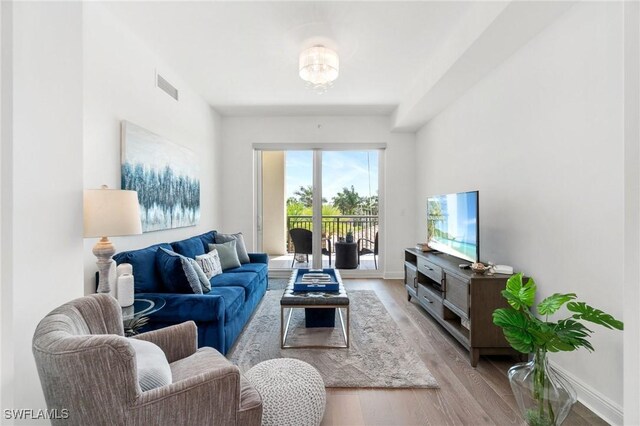 4800 Pelican Colony Blvd Unit 303, Bonita Springs, FL 34134 - living area featuring light wood-style floors and baseboards
