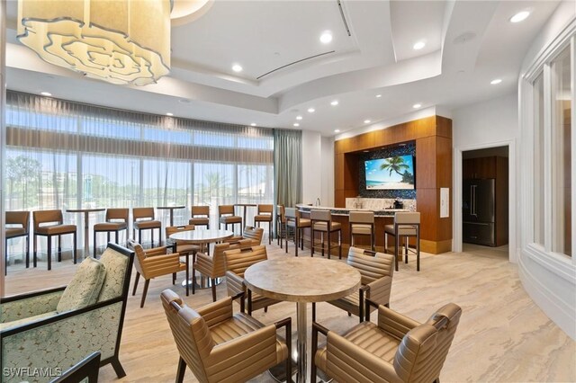 4800 Pelican Colony Blvd Unit 303, Bonita Springs, FL 34134 - dining space featuring a raised ceiling, recessed lighting, and light wood-style flooring