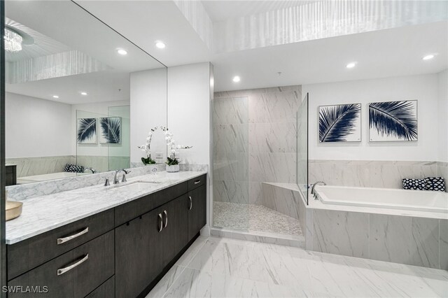 4800 Pelican Colony Blvd Unit 303, Bonita Springs, FL 34134 - bathroom featuring a garden tub, vanity, marble look tile flooring, a marble finish shower, and recessed lighting