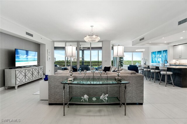 4800 Pelican Colony Blvd Unit 303, Bonita Springs, FL 34134 - living room featuring a chandelier, crown molding, expansive windows, and light tile patterned floors