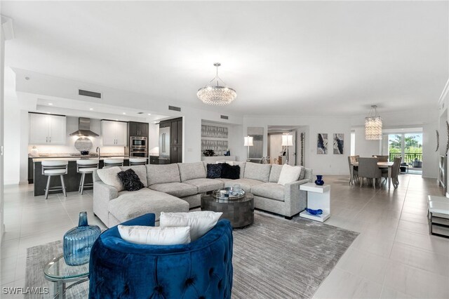 4800 Pelican Colony Blvd Unit 303, Bonita Springs, FL 34134 - living room with a chandelier and light tile patterned flooring