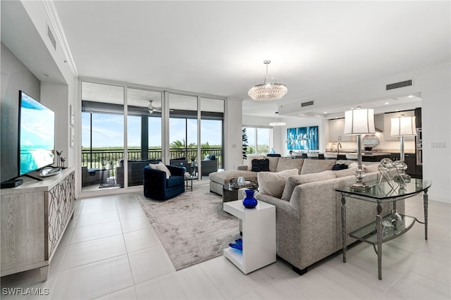4800 Pelican Colony Blvd Unit 303, Bonita Springs, FL 34134 - living room featuring a chandelier, expansive windows, and light tile patterned floors
