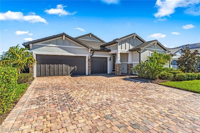 4424 Owens Way, Ave Maria, FL 34142 - craftsman house featuring an attached garage, decorative driveway, stucco siding, stone siding, and board and batten siding