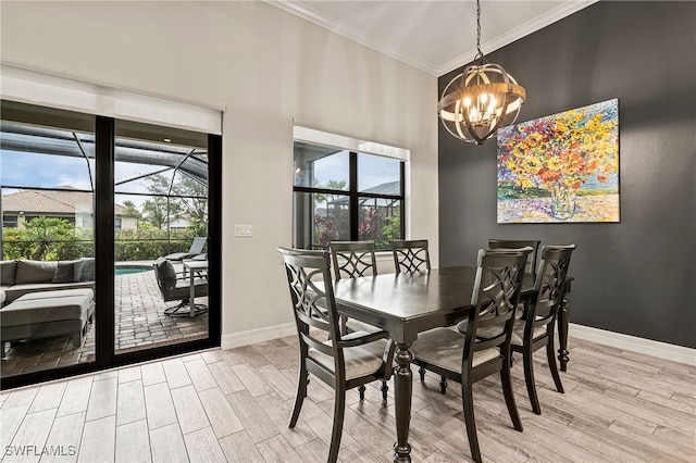4424 Owens Way, Ave Maria, FL 34142 - dining area with crown molding, a chandelier, wood finished floors, and baseboards