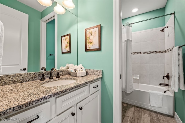 4424 Owens Way, Ave Maria, FL 34142 - bathroom featuring vanity, wood finished floors, shower / bath combo, and baseboards