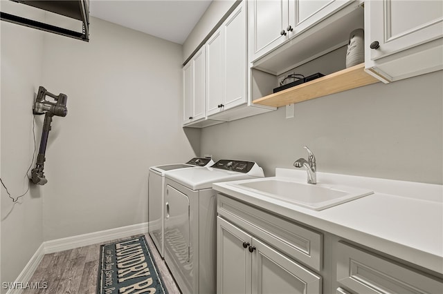 4424 Owens Way, Ave Maria, FL 34142 - laundry area with cabinet space, washer and clothes dryer, wood finished floors, and baseboards