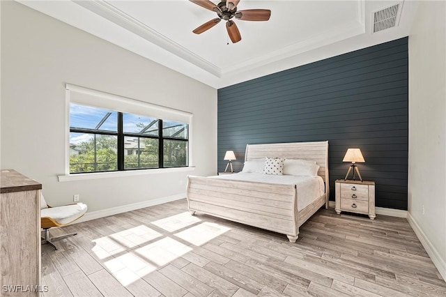 4424 Owens Way, Ave Maria, FL 34142 - bedroom with light wood-style flooring, baseboards, crown molding, ceiling fan, and an accent wall
