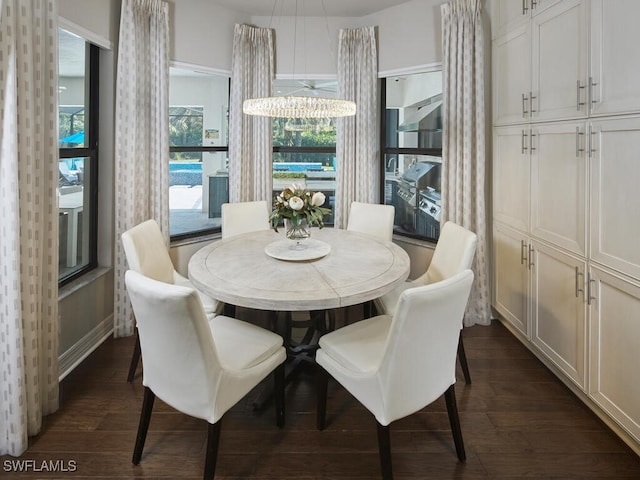 dining space with dark wood-type flooring and baseboards