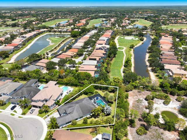 aerial view of residential area with property boundaries highlighted, a local golf course, and a large body of water