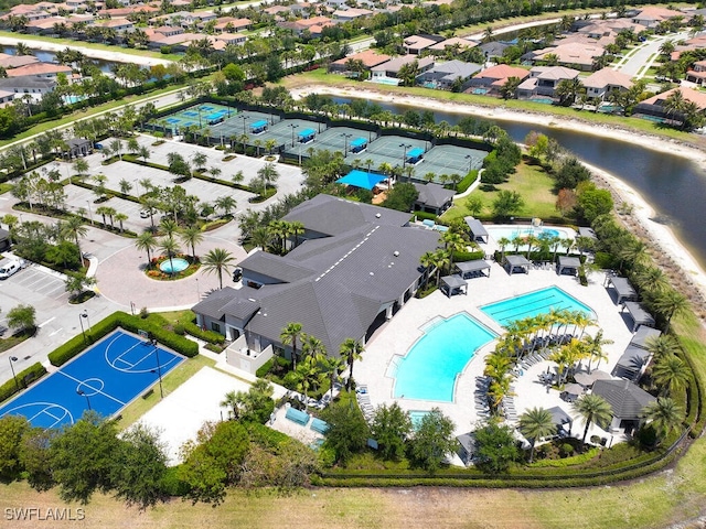 aerial view of residential area featuring a pool area and a nearby body of water