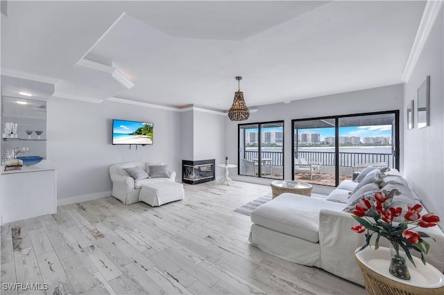 410 La Peninsula Blvd Unit 410, Naples, FL 34113 - living area with crown molding, baseboards, and wood finished floors