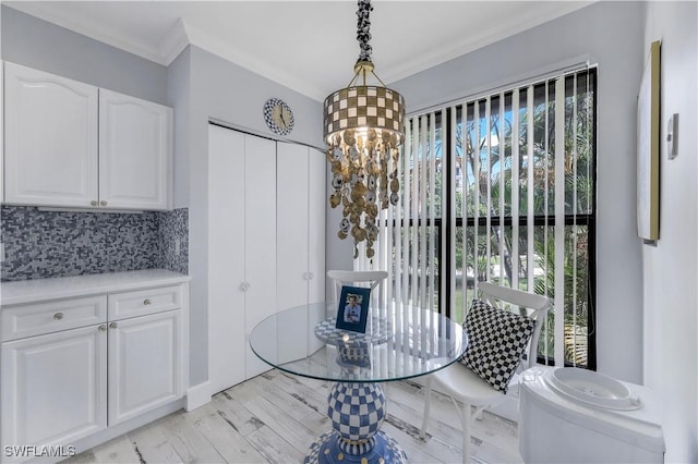 410 La Peninsula Blvd Unit 410, Naples, FL 34113 - dining room with ornamental molding and a chandelier
