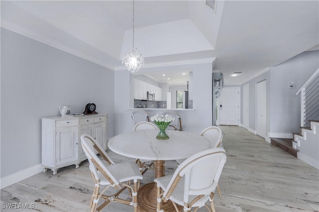 410 La Peninsula Blvd Unit 410, Naples, FL 34113 - dining room with crown molding, visible vents, light wood-style flooring, and stairway
