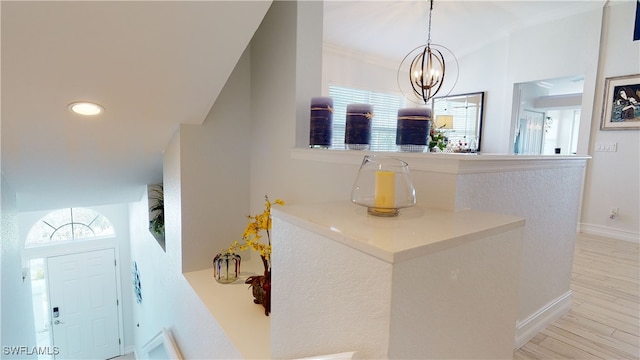 interior space featuring an inviting chandelier, recessed lighting, baseboards, and wood finished floors