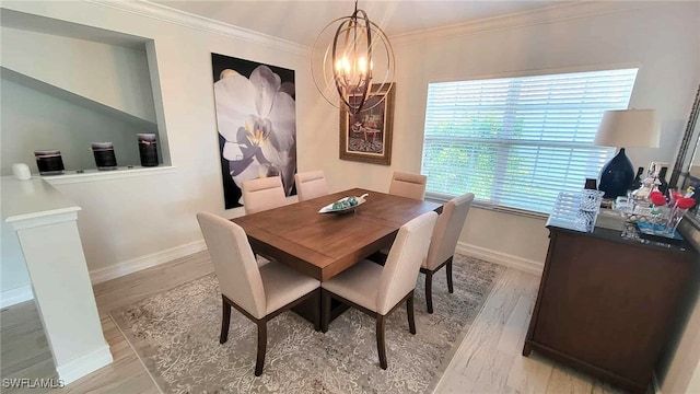 dining area featuring baseboards, a notable chandelier, ornamental molding, and light wood-type flooring