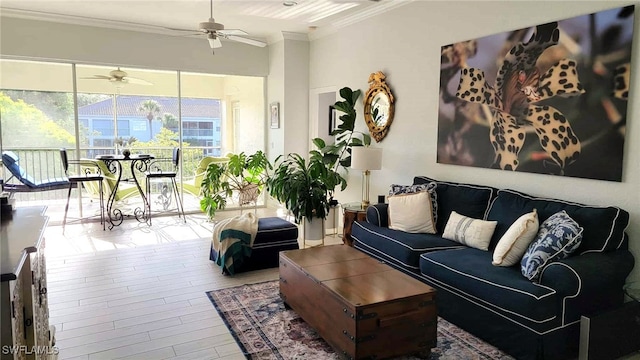 living area featuring crown molding, a ceiling fan, and wood finished floors