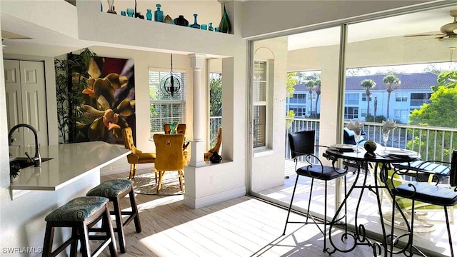 sunroom with plenty of natural light and a sink