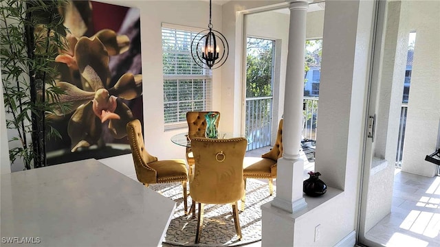 dining area with decorative columns and a chandelier