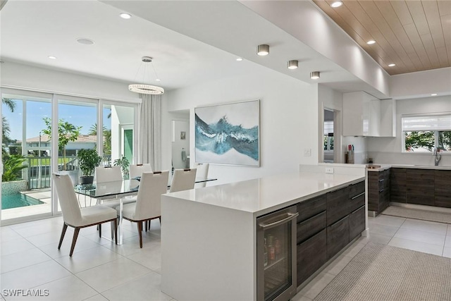 724 Plantation Ct, Marco Island, FL 34145 - kitchen with modern cabinets, beverage cooler, light countertops, a sink, and recessed lighting